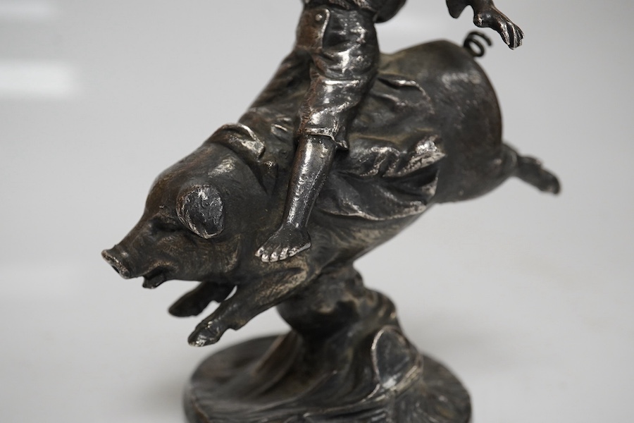 An early 20th century car mascot designed by Franz Bergmann ‘Boy riding a pig’, 12.5cm high. Condition - good, missing a small section in the right hand